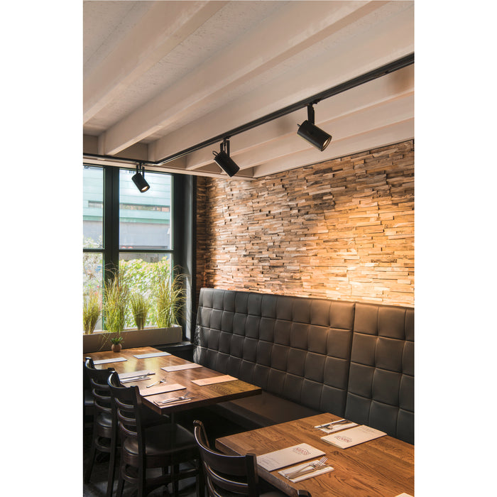 Interior with black track lighting, wood accent wall, and leather booth seating.