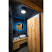 Modern bathroom with wood vanity, white vessel sink, round LED mirror, and wood stall door.