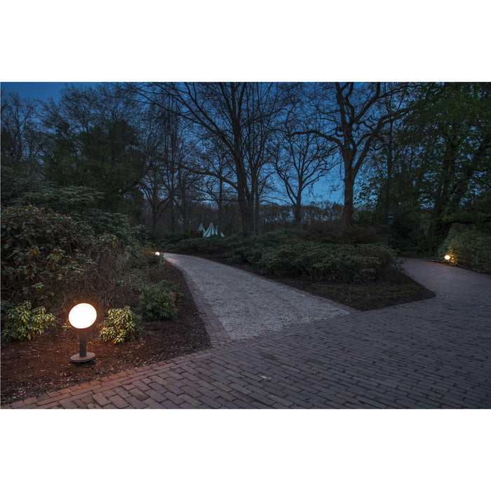Globe bollard light, black finish, on path.