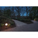 Globe bollard light, black finish, on path.
