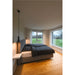 Bedroom with gray upholstered bed frame, black plaid bedding, wood floors, and black pendant lights.
