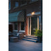 Dark bronze outdoor LED wall light fixture mounted above a green front door.