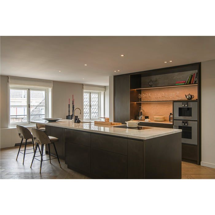 Modern kitchen with dark cabinets, marble countertop island, and open shelving.