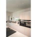 Modern kitchen with white cabinets, black Siemens ovens, and recessed ceiling lights.