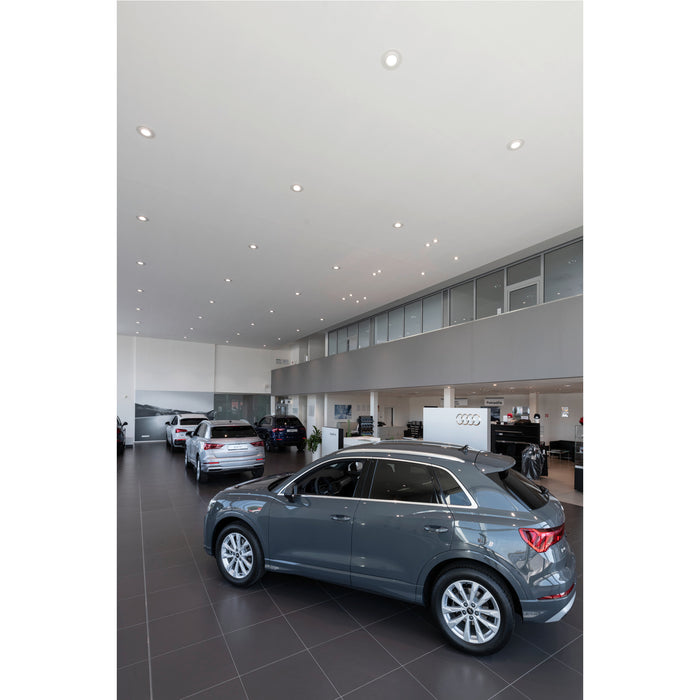 Audi Q3 in gray at a dealership showroom.