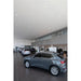 Audi Q3 in gray at a dealership showroom.