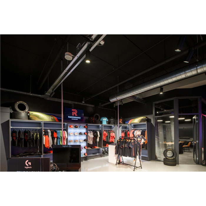 Racesquare Alkmaar store interior with apparel, racing simulator, tires, and meeting room.