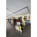Retail store interior with workwear clothing displays, black track lighting, and dark wood-look flooring.