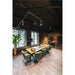 Conference room with wood table, green upholstered chairs, track lighting, and wood-look tile flooring.