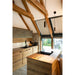 Modern kitchen with wood cabinets, black sink and faucet, stone wall, and black pendant lights.