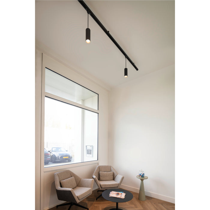 Black track lighting with two cylindrical spotlights, mounted on a white ceiling.