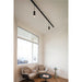 Black track lighting with two cylindrical spotlights, mounted on a white ceiling.