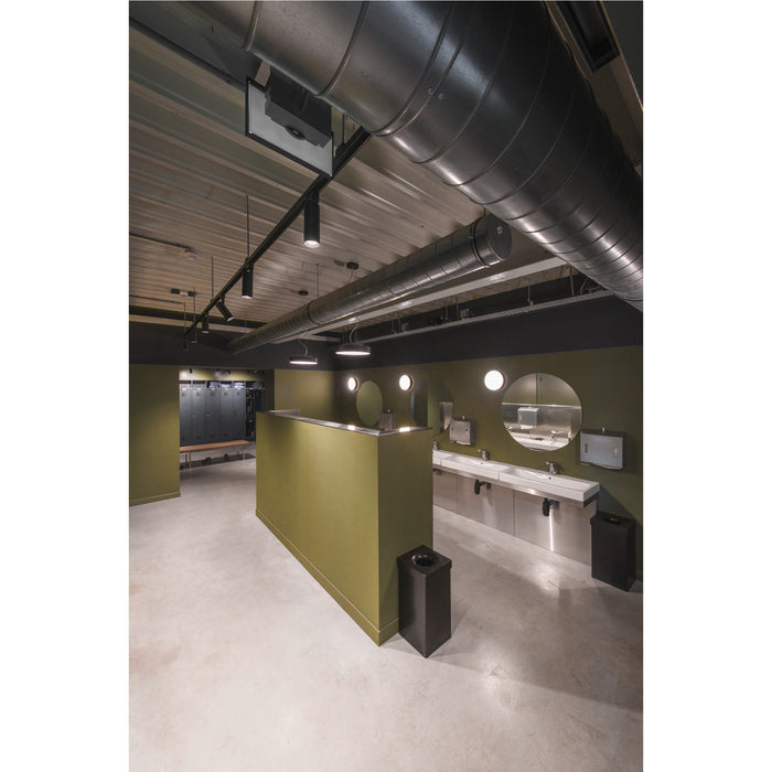 Modern restroom with stainless steel sinks, olive green walls, black ceiling ductwork, and lockers.