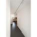 White cylinder track lighting fixture, ceiling mounted.