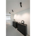 Interior with black metal cabinets, wall clock, and ceiling-mounted black track lighting.