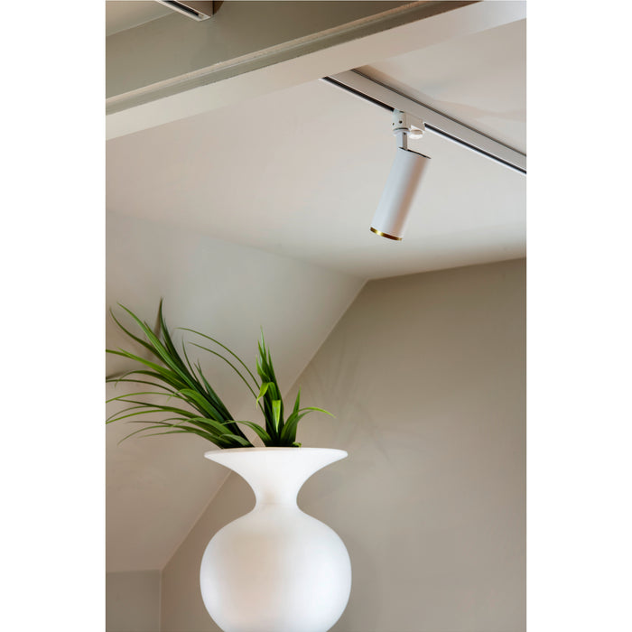 White track lighting fixture, metal, with gold accent, ceiling mounted.