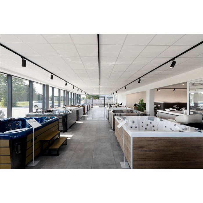 Hot tub showroom featuring various models with wood-look and solid color cabinets.
