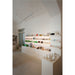 Interior view of a retail store with white shelving and cabinets displaying various beauty and skincare products.