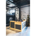 Bike shop interior with a light wood and gray reception desk, black pendant lights, and Auvray security products display.