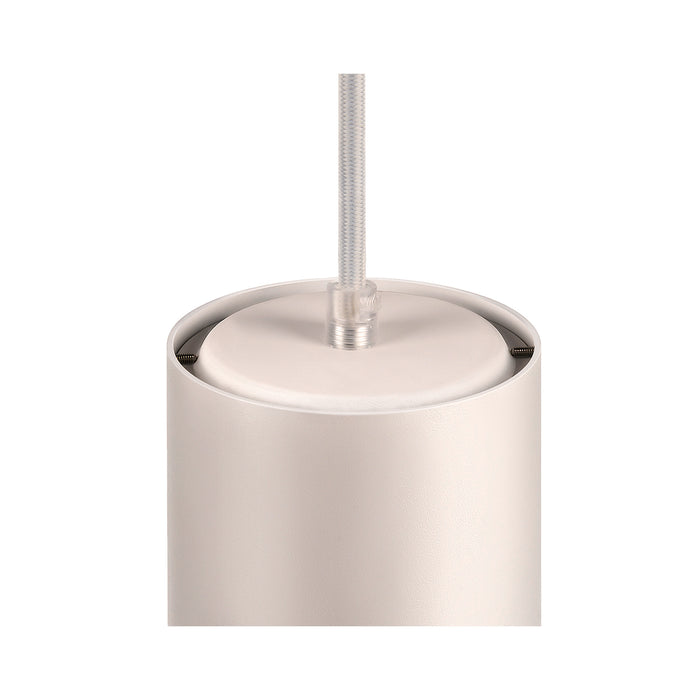 Close-up of a white, cylindrical, metal pendant light fixture with a textured finish and cord suspension.