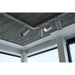White track lighting system with cylindrical spotlights, ceiling mounted.