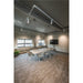 Conference room with white table, gray chairs, track lighting, and brown carpet.