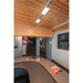 Museum interior with wood slat ceiling, track lighting, gray reception desk, and artwork.