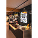 Bike shop interior with black pendant lights, metal-topped counter, and Trek bike display.