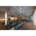 Conference room with blue and beige chairs, gray carpet, and track lighting.
