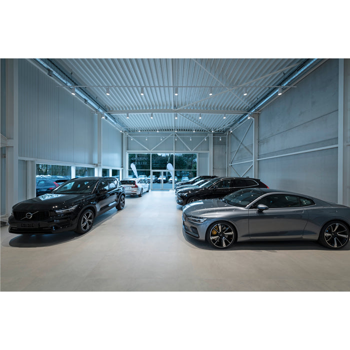 New car showroom with black and gray Volvo and Polestar vehicles.