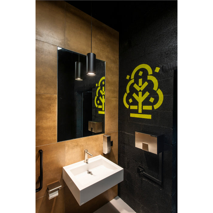 Modern bathroom with white wall-mounted sink, black pendant lights, bronze tile, and black textured wall with yellow tree graphic.