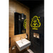 Modern bathroom with white wall-mounted sink, black pendant lights, bronze tile, and black textured wall with yellow tree graphic.