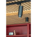 Black track lighting fixture, cylinder shape, mounted on ceiling track.