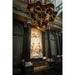 Ornate church interior featuring a white marble relief sculpture and gilded wood carvings.