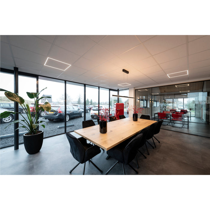Conference room with light wood table, black velvet chairs, and linear LED ceiling lights.