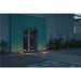 Black bollard lights illuminating a building entrance at dusk.