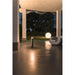 Modern gray bollard light fixture, ground mounted.