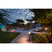 Bronze finish outdoor path light, post mounted, illuminating a modern garden at dusk.