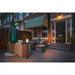 Outdoor patio with wicker furniture and dark gray, pole-mounted bollard lights.
