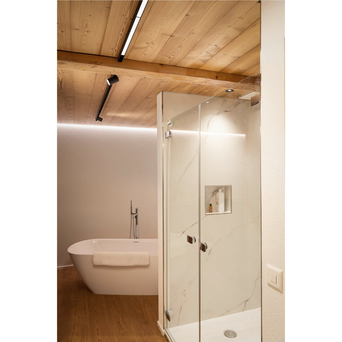 Bathroom with white freestanding tub, glass shower with marble-look tile, and wood ceiling.