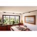 Modern dining room with black track lighting, large window, and painting.