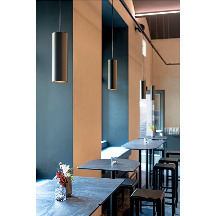 Metal cylinder pendant lights, matte black finish, suspended from ceiling in restaurant setting.
