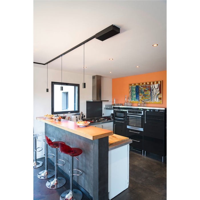Modern kitchen with black track lighting, red acrylic bar stools, wood countertop, and black glossy cabinets.