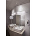 Modern bathroom with white ceramic sinks, wall-mounted chrome faucets, and linear LED vanity lights.