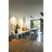 Modern dining room with white bench seating, gray table with gold legs, and gray upholstered chairs.