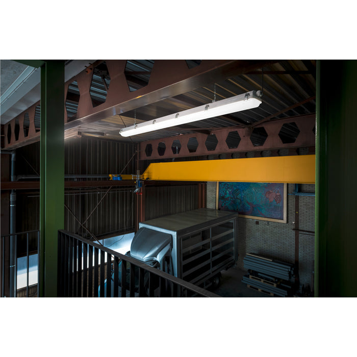White LED linear light fixture, suspended from industrial ceiling.
