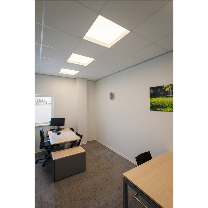 Office space with drop ceiling, recessed square lights, light wood desks, gray storage, and gray patterned carpet.