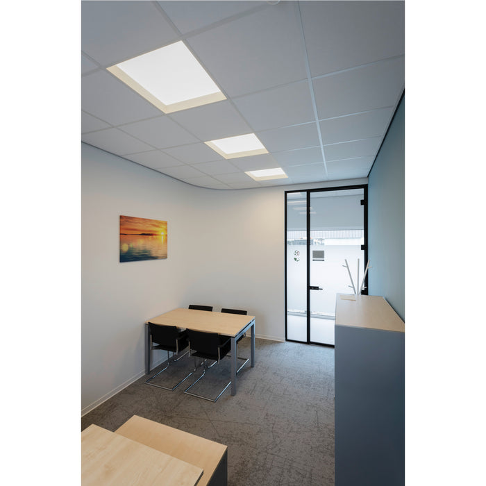 Office interior with recessed square LED ceiling lights, a wood table with metal legs, and black chairs.