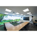 Conference room with wood tables, black chairs, large screen, and nature scene wall mural.