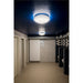 White acrylic flush mount ceiling light fixture with blue accent lighting in a commercial restroom.